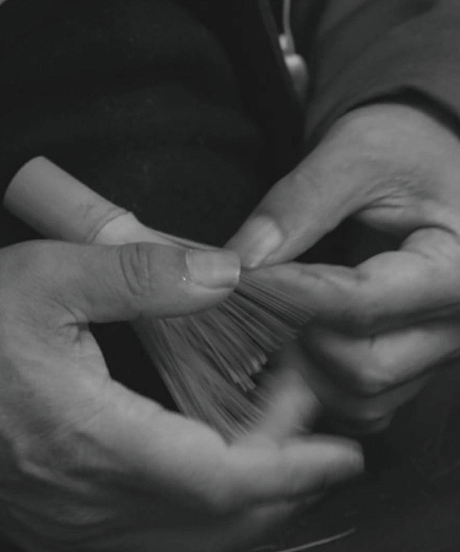 Close-up of Korean Master Heo's hands meticulously crafting the bamboo matcha whisk. This handcrafted chasen process ensures premium quality.