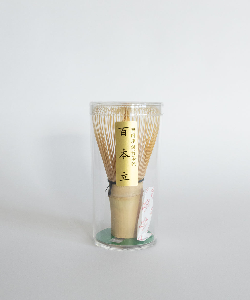 Korean bamboo chasen whisk packaged in a clear protective container. 100-prong design.