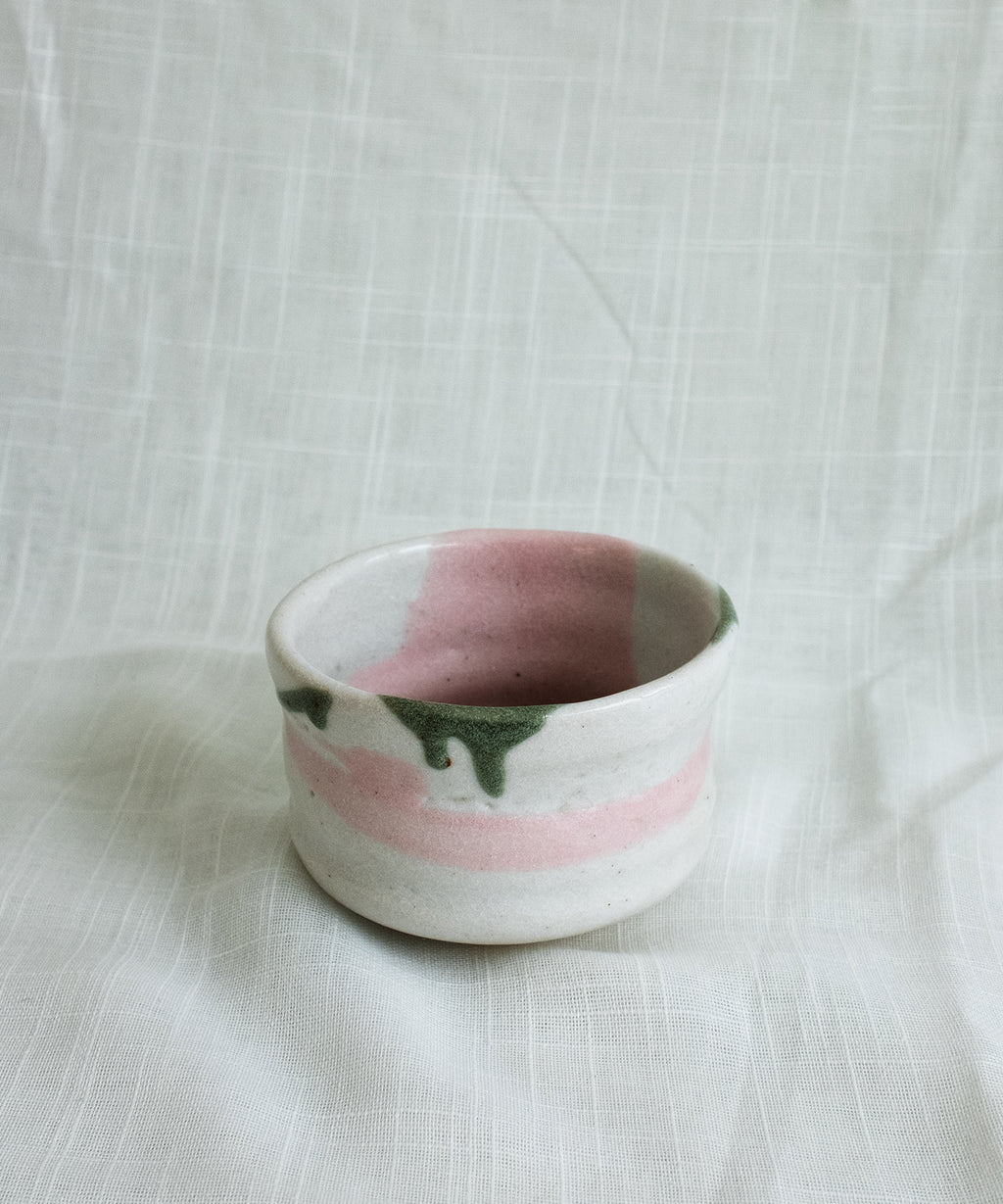 Side view of handcrafted Japanese Mino matcha bowl in green and pink glaze, unique handmade chawan pottery for matcha whisking