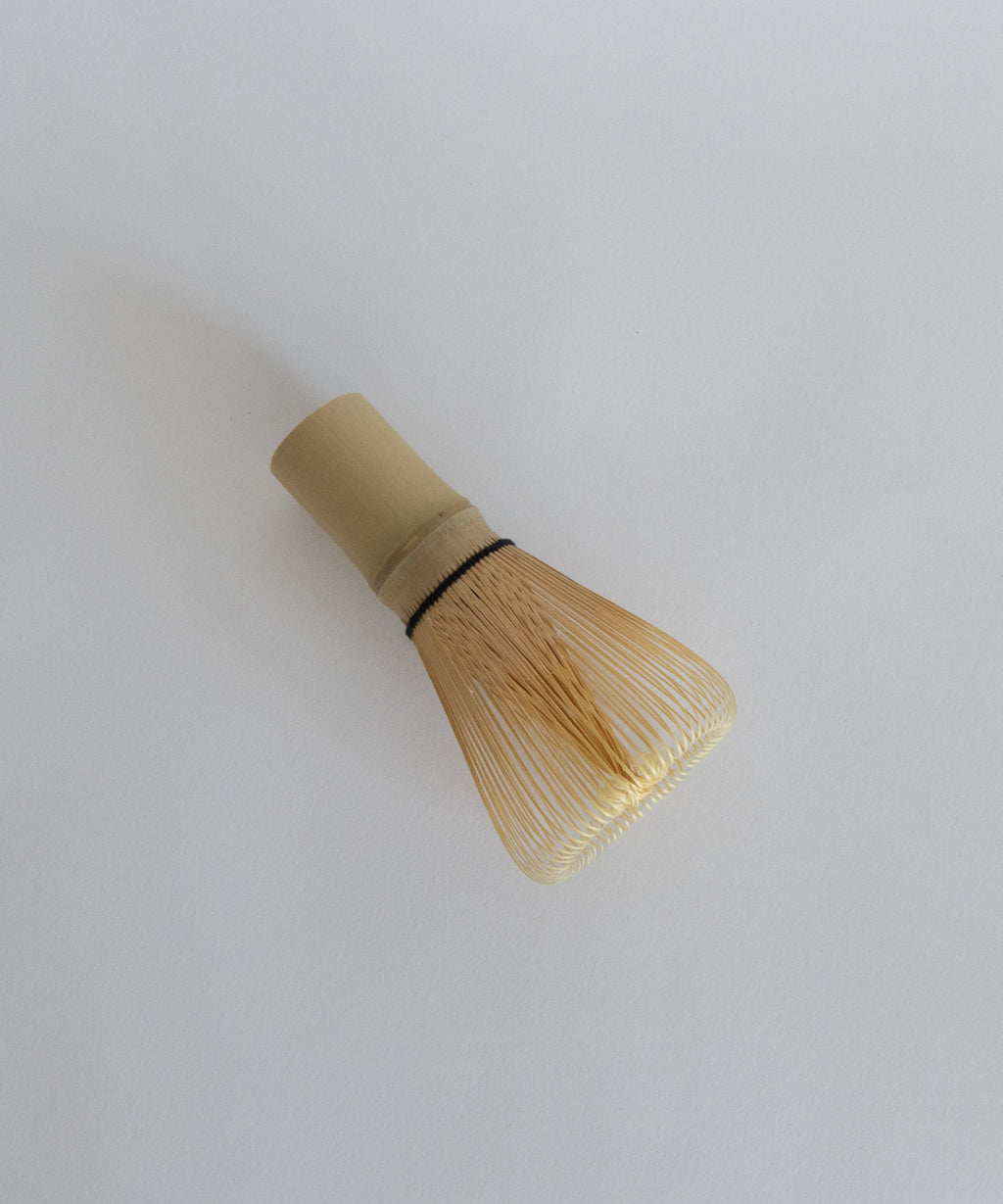 Side angle of the bamboo matcha whisk highlighting the delicate tines.