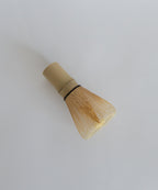 Side angle of the bamboo matcha whisk highlighting the delicate tines.